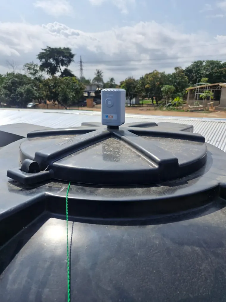 A MIOT ultrasonic level sensor mounted on the lid of a rooftop water tank.
